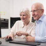 Senior couple reviewing their retirement account paperwork and discussing IRA withdrawal options.